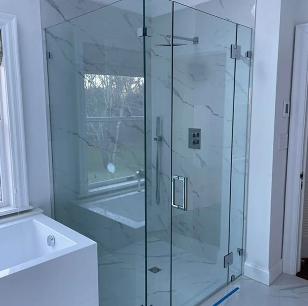 Frameless glass shower enclosure